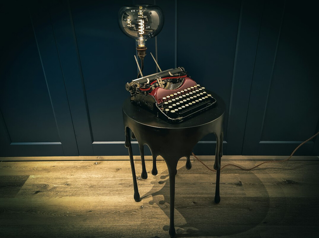 Vintage typewriter on an editorial desk with documents and a cup of coffee