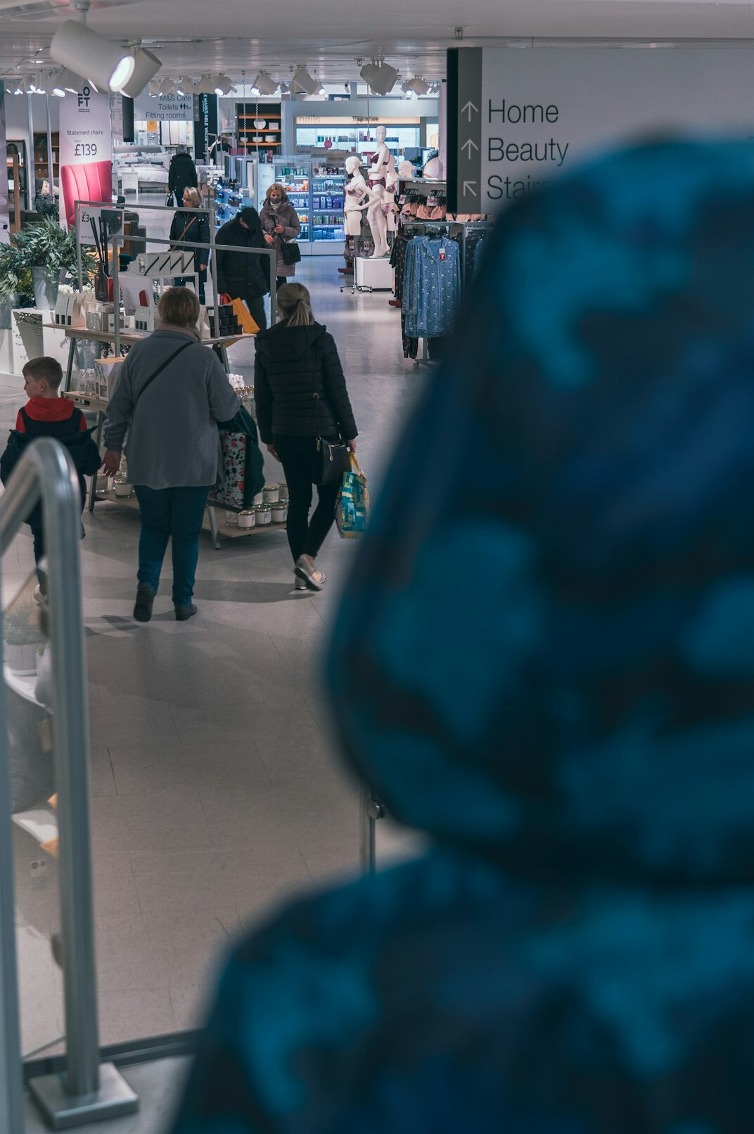 store detective watching shoppers